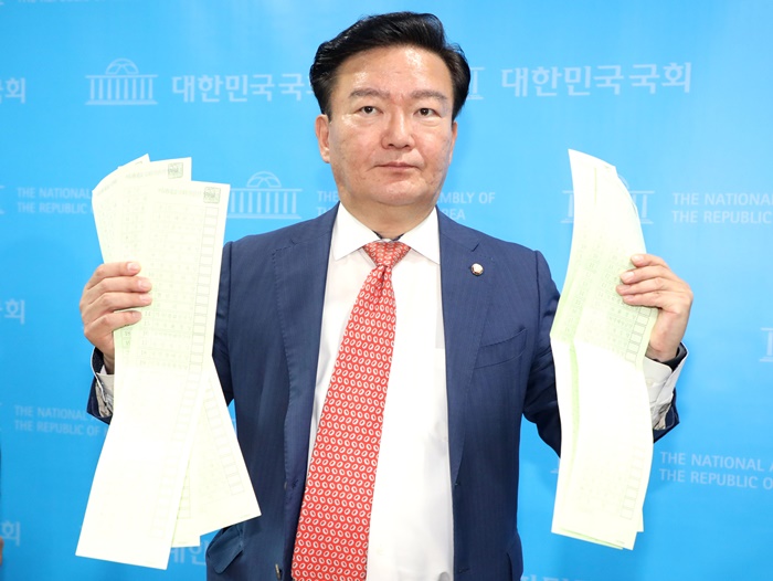 민경욱 미래통합당 의원이 지난 21일 서울 여의도 국회 소통관에서 지난 11일에 공개했던 투표용지를 들고 총선 부정선거 의혹을 제기하고 있다. /뉴시스