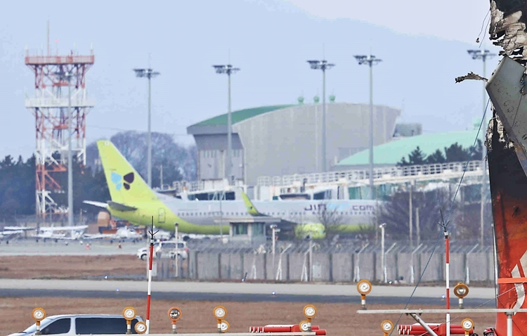 지난해 12월 29일 오전 무안공항에서 제주항공 여객기가 콘크리트 구조물과 흙더미로 만들어진 로컬라이저 둔덕에 부딪히는 사고가 발생해 무안공항이 폐쇄됐다. 문제는 사고 직전 무안공항에 착륙한 진에어 항공기(HL8012) 1대가 오가지 못하고 있어 대책 마련이 필요해 보인다. 사진은 무안공항 제주항공 사고 현장 너머에 주기 중인 진에어 항공기. / 뉴시스