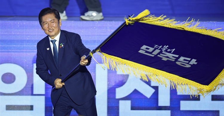정청래 더불어민주당 신임 당대표가 2일 경기 고양시 킨텍스에서 열린 제2차 임시전국당원대회에서 당기를 흔들고 있다. / 뉴시스