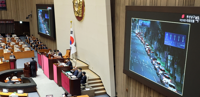 6일 오후 국회에서 국민의힘 박수영 의원이 김민석 국무총리에게 주유소 차량행렬 사진을 보여주며 최고가격제에 대한 대정부질문을 하고 있다. / 뉴시스